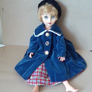 Doll with checkered dress and blue coat